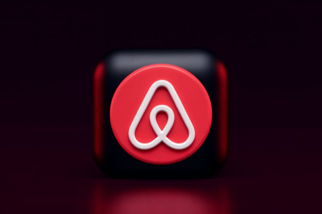 Stylised Airbnb logo on dark background.